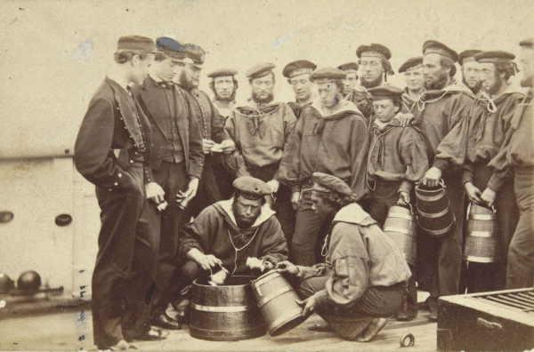 A group of sailors waiting to receive a ration of rum